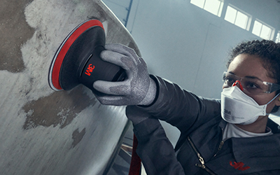 woman using xtract to sand boat