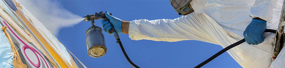 photo of man spary coating an aircraft