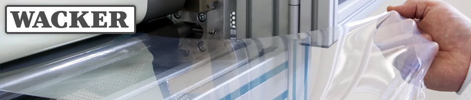 WACKER logo with a photo of silicone film produced from a machine while being held taut by a technicians hand.