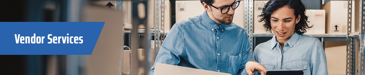 two people looking at tablet in warehouse